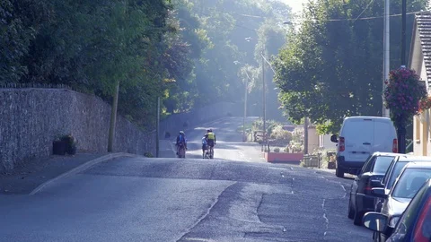Cyclists on Sun-washed Road County Cavan Ireland Stock Footage 98185786