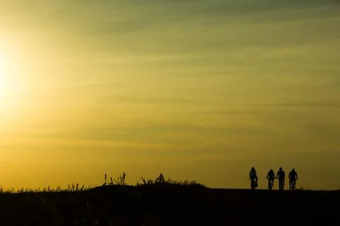Cyclists at the sunset Stock Photos