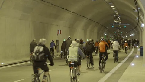 Cyclists in underground tunnel Stock Footage 69855476