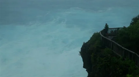 Cyclone driven waves crash against rocky shoreline Stock Footage 50302229