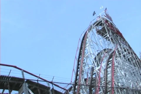 Cyclone with Roller Coaster going up and down Stock Footage 8540287