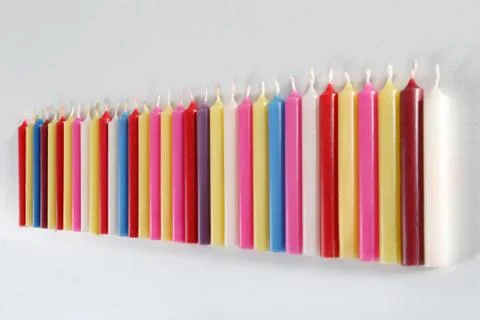 Cylindrical colored candles Stock Photos
