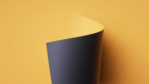 Cylindrical curl forms from a yellow sheet; the black side wraps inside Stock Footage 322135018
