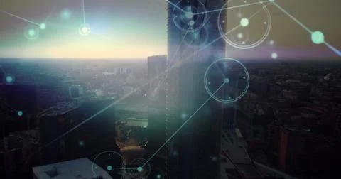 Cylindrical glass skyscraper and rectangular tower glowing at dusk in skyline, Stock Photos