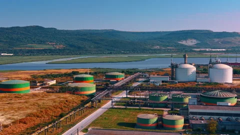Cylindrical industrial storage tanks. Large green and orange painted reservoirs Stock Footage 343376315