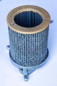 A cylindrical pleated wire mesh fluid filter cartridge isolated background. Foto stock