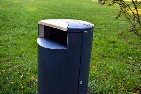 Cylindrical Trash Bin Next to a Bright Blue and Red Basketball Court in Tallinn Stock Photos