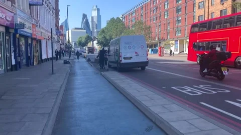 Cyling along cycle path in east London Aldgate Whitechapel area Stock Footage 139485602