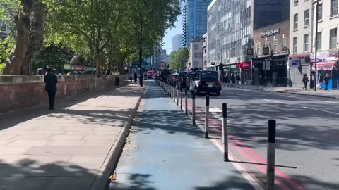 Cyling along cycle path in east London Aldgate Whitechapel area Stock Footage 139485621