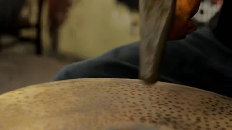 Cymbal worker making cymbals with hammer Stock Footage 237622606