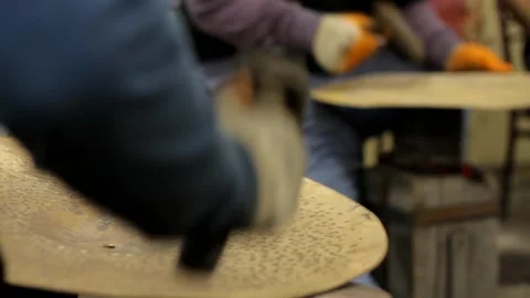 Cymbal workers making cymbals with hammer close up Stock Footage 237622542