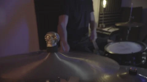 Cymbals with gold skull while drummer playing in a studio recording session Stock Footage 129098104