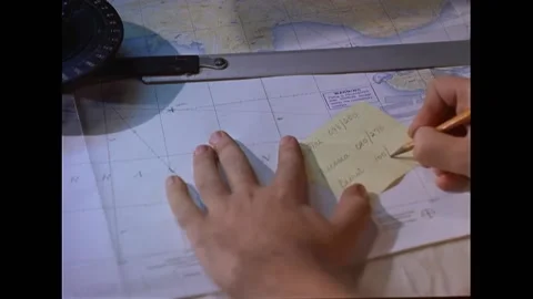 CYPRUS - 1960 - A worker plots coordinates on a map inside the USS Essex combat Stock Footage 337710019
