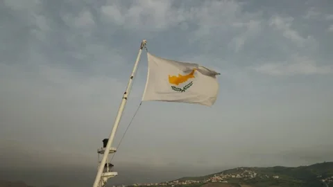 Cyprus flag waving on ship mast over hills and coastline Stock Footage 337483115