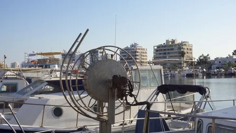 CYPRUS, LARNACA - CIRCA May 2019: Fishing wheel at city pier with fishing boats 스톡 동영상 109449292