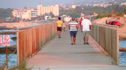Cyprus, Larnaca, September 06, 2019. People walk across the bridge on summer Stock Footage 138997401
