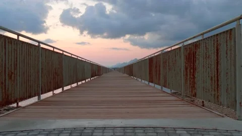 Cyprus, Larnaca, September 16, 2019. Athletic man is walking along long bridge Stock Footage 134843785