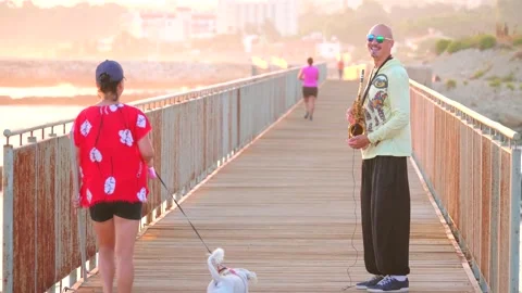 Cyprus, Larnaca, September 16, 2019. Young bald man street musician saxophonist Stock Footage 148028640