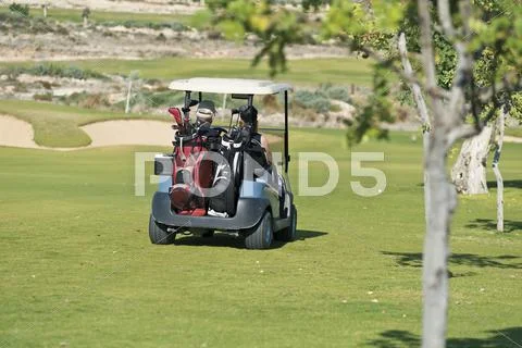 Cyprus, Man and woman sitting in golf cart Stock Photos