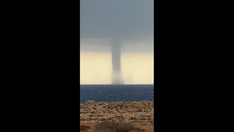 Cyprus: Rare waterspout forms off the coast in Ayia Napa, Cyprus Stockbeeldmateriaal 344292405
