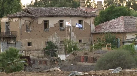 Cyprus war zone - destroyed house, Greek Cypriot flags Stock Footage 61514347