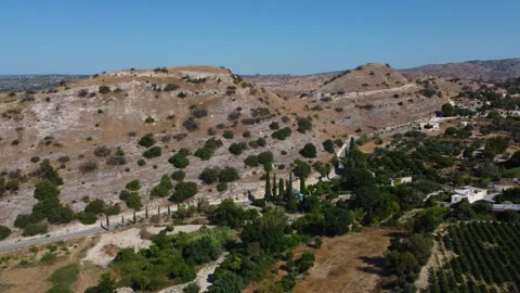 Cyprus. White winery building and hillside vineyard rows. Right tracking aerial Vídeos de archivo 345221901