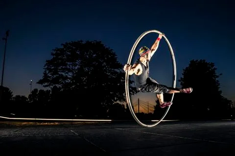 Cyr wheel performance session at night in Riga. Stock Photos