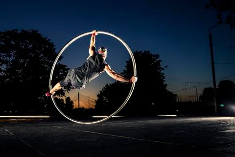 Cyr wheel performance session at night in Riga. Stock Photos