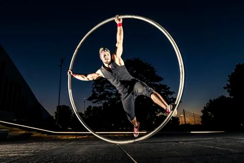 Cyr wheel performance session at night in Riga. Stock Photos