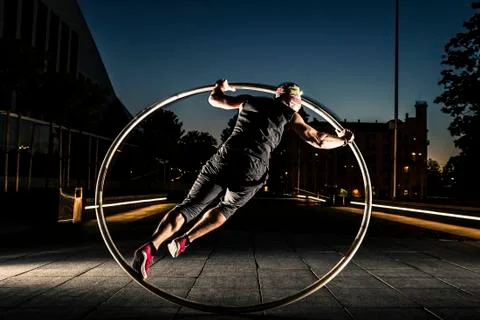 Cyr wheel performance session at night in Riga. Foto stock