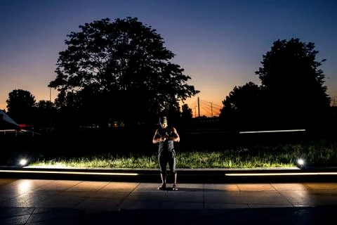 Cyr wheel performance session by young man at night. Stock Photos