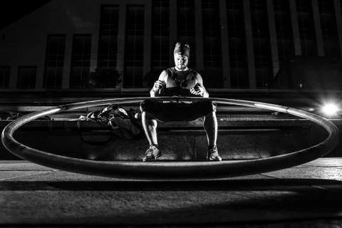 Cyr wheel performance session by young man at night. Stock Photos