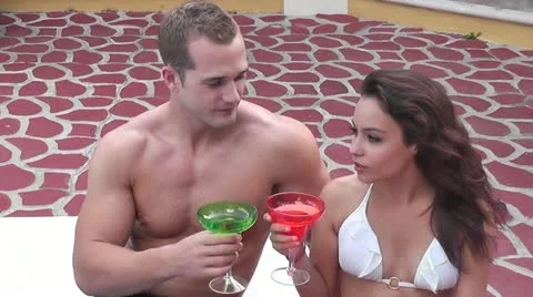 CZA-0065 POOLSIDE COUPLE WITH DRINKS Stock Footage 10859682