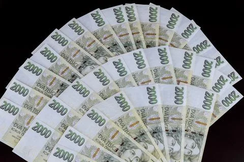 Czech crowns with a face value of two thousand. Lots of czech money on a blac Stock Photos
