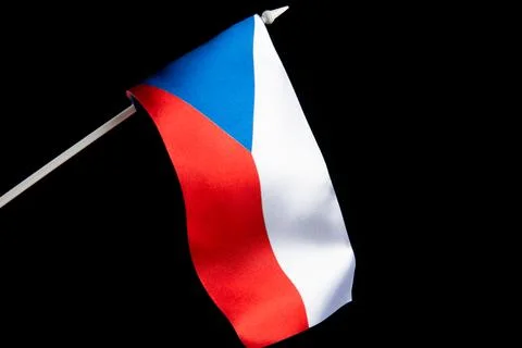 The Czech flag on a black background is developing and flying in the wind. Czech 库存照片
