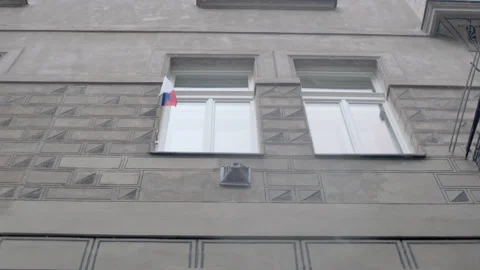 Czech flag on a praguese facade with snow falling Stock Footage 147927222