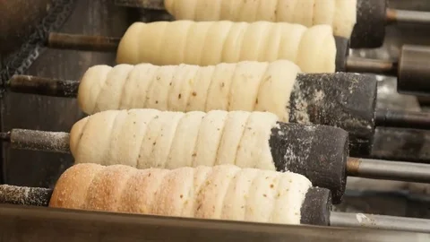 The Czech national dish Trdelnik is cooked and roasted Stock Footage