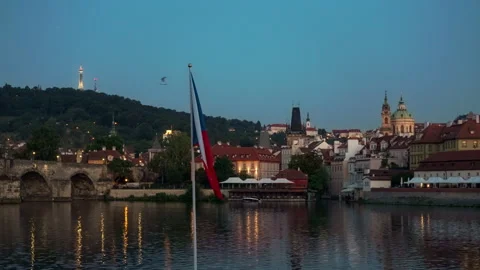 Czech national flag flutters in front of illuminated Prague skyline at dusk Video stock 341592509