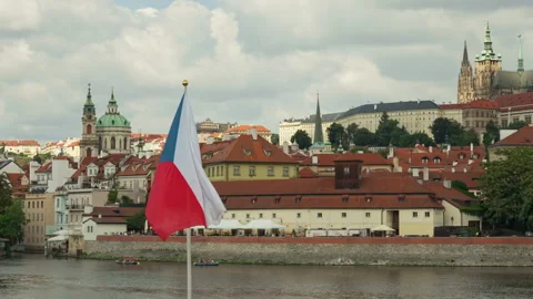 The Czech national flag flutters in the wind over historic Prague skyline. Stock-Footage 341971492