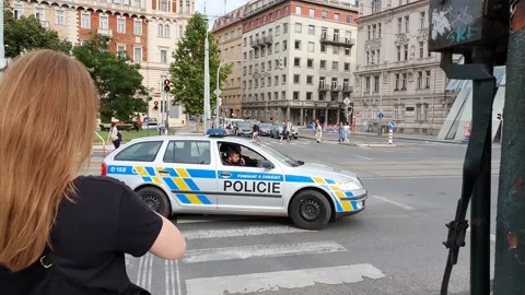 Czech police drive through the intersection Stock Footage 162987781