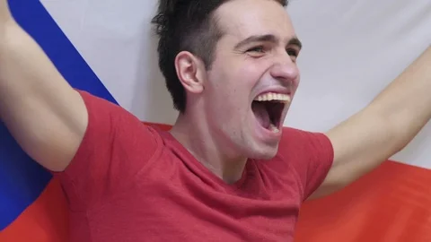 Czech Young Man celebrating while holding the flag of Czech Republic in Slow Stock Footage 89651937