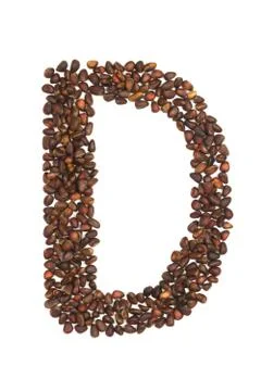 D letter made of cedar  nuts Stock Photos
