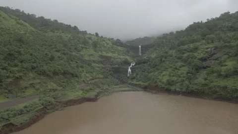 D log aerial drone shot of Beautiful waterfall in rainy season Video stock 156893098