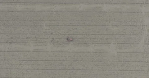 D-log aerial drone top down shot bird eye view of red tractor driving in op.. Stock Footage 284088201