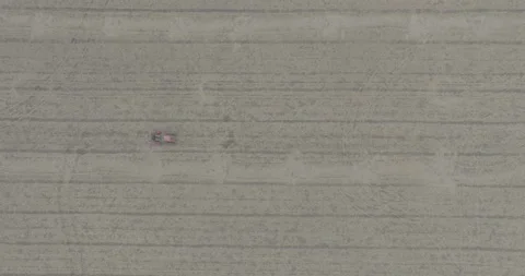 D-log aerial drone top down shot bird eye view of red tractor driving in op.. Stock Footage 284088455