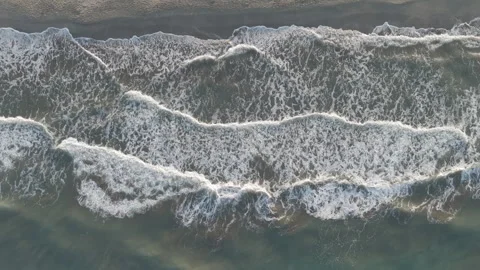 D-Log M. Gelemis, Turkey. Top down aerial view of white foamy waves on shoreline Video stock 320154176