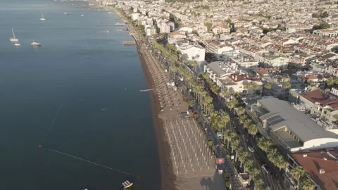 D-Log M. Marmaris, Turkey. Aerial flight along empty beaches with sunbeds and Stock Footage 319816945