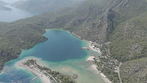 D-Log M. Oludeniz, Turkey. Aerial drone view of a paraglider with red parachute Vidéo 321582002