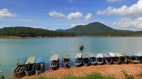 Da Lat - May 2015: Turquoise lake with boats arriving and leaving dock. 4K Stock Footage 51599113