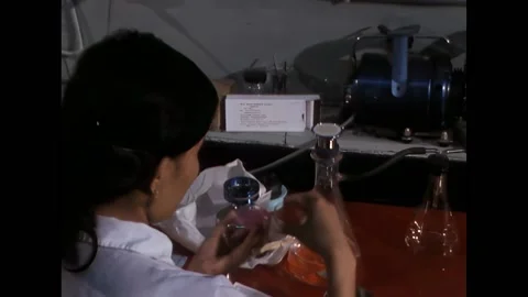 DA NANG - 1968 - The technician uses forceps to pick up a new filter from a Stock Footage 316680882
